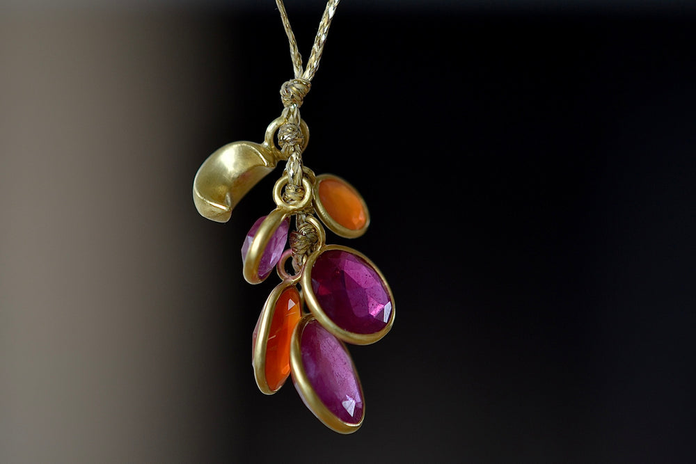 Close up of Pippa Small's Colette Set Ruby and Carnelian Necklace with gold moon.