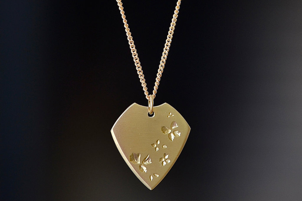 Close up of Petal Print Pick Necklace by Kaylin Hertel.