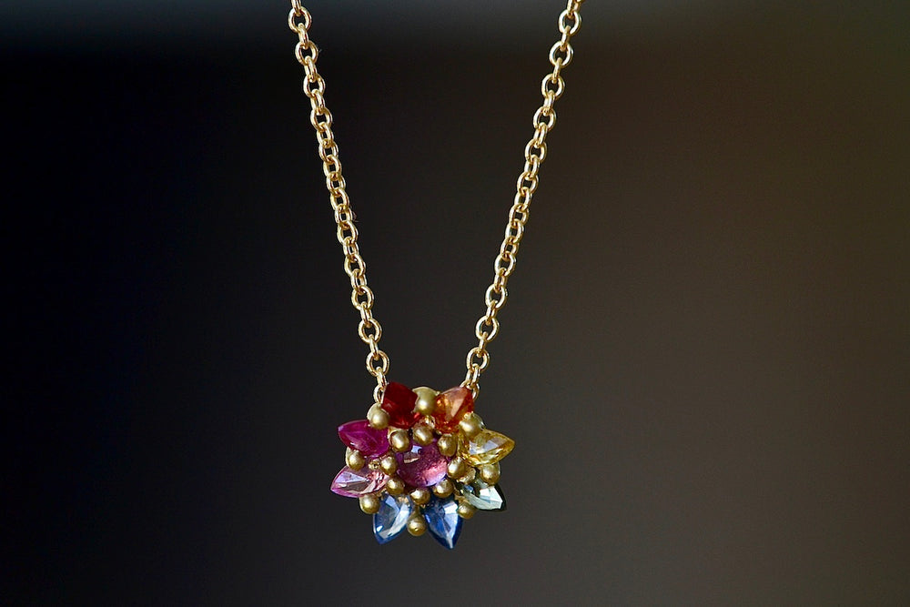 Close up of Daisy Necklace in rainbow by Polly Wales.