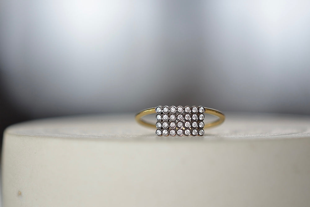 Charnières Rectangular Ring designed by Yannis Sergakis is a rectangular formation of twenty-eight bezel set and rhodium plated round cut diamonds on a gold band in 18k gold. 