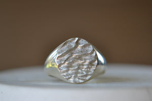 Close up of White gold Tidal round signet by Fraser Hamilton.