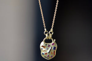 Close up of Polly Wales Small Harlequin Coeur de Confetti Padlock Necklace on 18k gold chain.