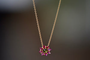 Daisy necklace by Polly Wales with green cabochon center and hot pink inverted and encrusted brilliant sapphires. 