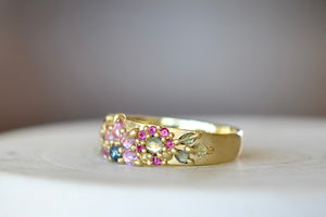 Side view of Rainbow Daisy Garland Ring designed by Polly Wales.