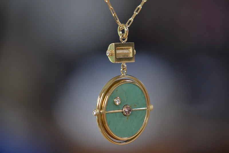 
            
                Load image into Gallery viewer, Side of  Grandfather Compass Pendant in Green Turquoise and Tanzanite by Retrouvai is a pendant necklace with stone inlay that is accented with a center gem stone in the front and back, and nine (9) round white diamonds.
            
        