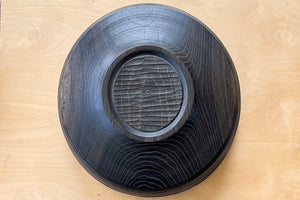 Circle Factory Bowl in Black Oak with grooves upside down.