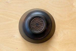 Circle Factory Bowl in stained black cherry upside down.