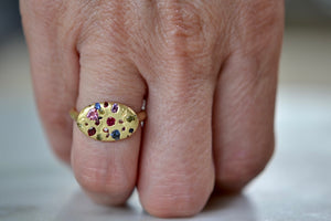 Wearing the Elysian Ring in Rainbow Sapphires by Polly Wales. Cast not set. Confetti style signet or pinky ring.
