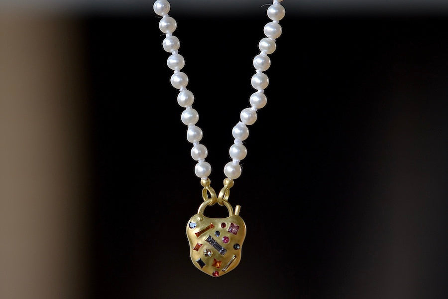 
            
                Load image into Gallery viewer, Polly Wales&amp;#39; Small Harlequin Coeur de Confetti Padlock Necklace shown on strand of fresh water pearls.
            
        