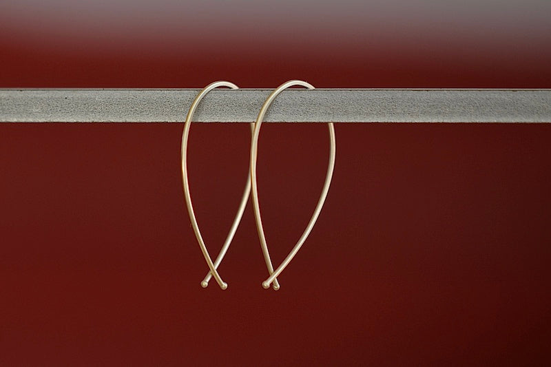 
            
                Load image into Gallery viewer, Carla Caruso 14k Yellow Gold Ribbon Hoops in Medium.
            
        