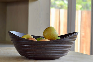 Circle Factory Brown Bowl in Black Oak with ridged detail and apples. Made and designed by George Peterson. 