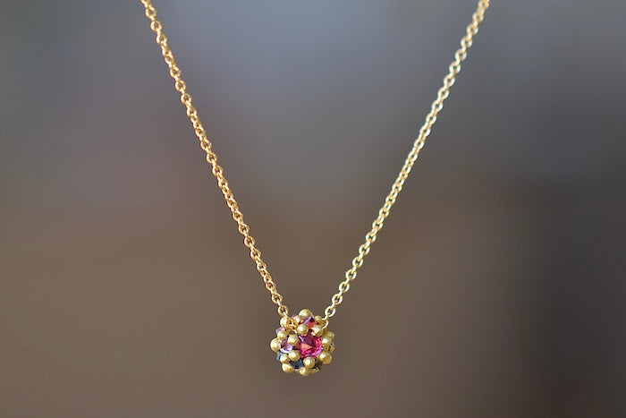 
            
                Load image into Gallery viewer, Polly Wales Small Sputnik Dome Pendant Necklace is a domed half sphere in 18k yellow gold with encrusted and inverted pink, blue and yellow sapphires around the circumference hangs on a beautiful chain. Cast Not Set. Recycled Gold.
            
        