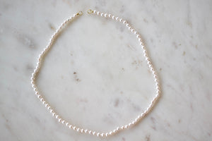 Small Seed Pearl Strand in White by Polly Wales is a A strand of a la carte fresh water seed pearls with gold bales on each end to fit a Polly padlock.