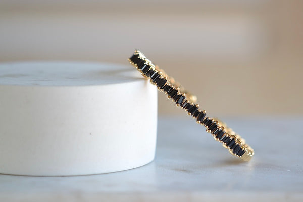 Black Sapphire Baguette Reborn Bangle Bracelet by Suzanne Kalan AKB454 is a prong set balck sapphire flexible sparkly cuff on trademarked fireworks setting.