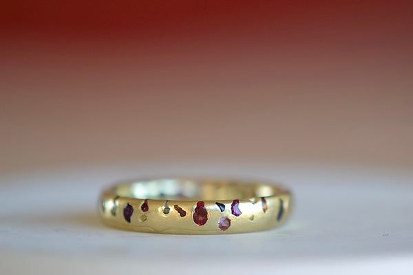 Polly Wales Classic Rainbow Confetti Band Ring in 18k recycled yellow gold with green, yellow, orange, blue, purple and pink sapphires and cast not set size 8.