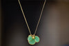 Colette Cluster Necklace in Chrysoprase with Gold Drops designed by Pippa Small is a Cluster of chrysoprase pendants bezel set stones in various sizes with two (2) 18k gold beads on 22" golden waxed cotton cord also known as the Flourishing Green necklace..