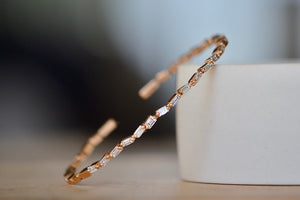 
            
                Load image into Gallery viewer, Suzanne Kalan Zig Zag Flexible Diamond Baguette Bangle Shimmering and bezel set white baguette diamonds are mixed with solid gold shaped baguettes on a thin and flexible rose gold cuff in 18k rose gold.
            
        