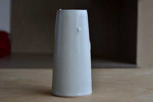 
            
                Load image into Gallery viewer, Hyejong Kim Tall White Pinched vase made in Seoul, Korea is aHand thrown porcelain in matte white glaze. Signed and one of a kind. Loewe Craft Prize Finalist.
            
        