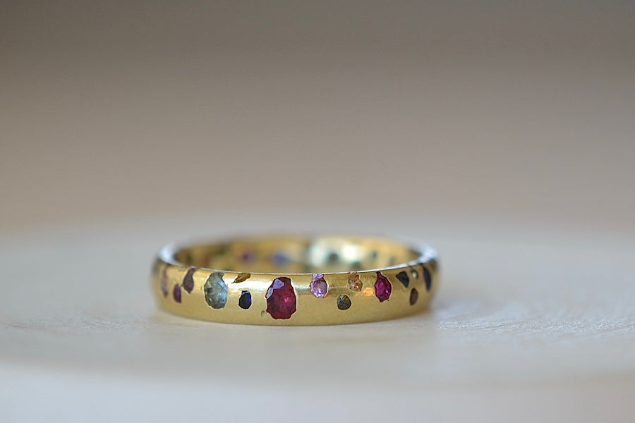 Rainbow Confetti Ring Size 7.5 by Polly Wales  is a narrow 18k gold band with speckled mixed sapphires around the circumference for a beautiful confetti-like appearance. Recycled gold. Cast not set. Handcrafted in Los Angeles.