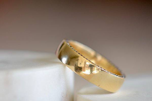 The Slim Pave Othello Cigar Band is a slim pavé 18k polished slightly rounded band by Lizzie Mandler with black diamonds on one side and white diamonds on the other. Handmade in Los Angeles.