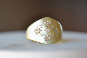
            
                Load image into Gallery viewer, Sierra&amp;#39;s Ring by Adel Chefridi is an 18k yellow gold shield, pinkie, or signet unisex  ring with inset white diamonds and engraving set in Adel&amp;#39;s &amp;quot;sun and moon&amp;quot; pattern available at OK.
            
        