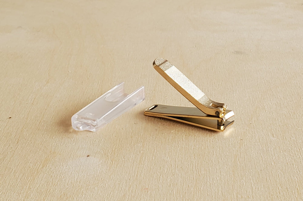 Japanese Nail Clippers in Gold with plastic case.