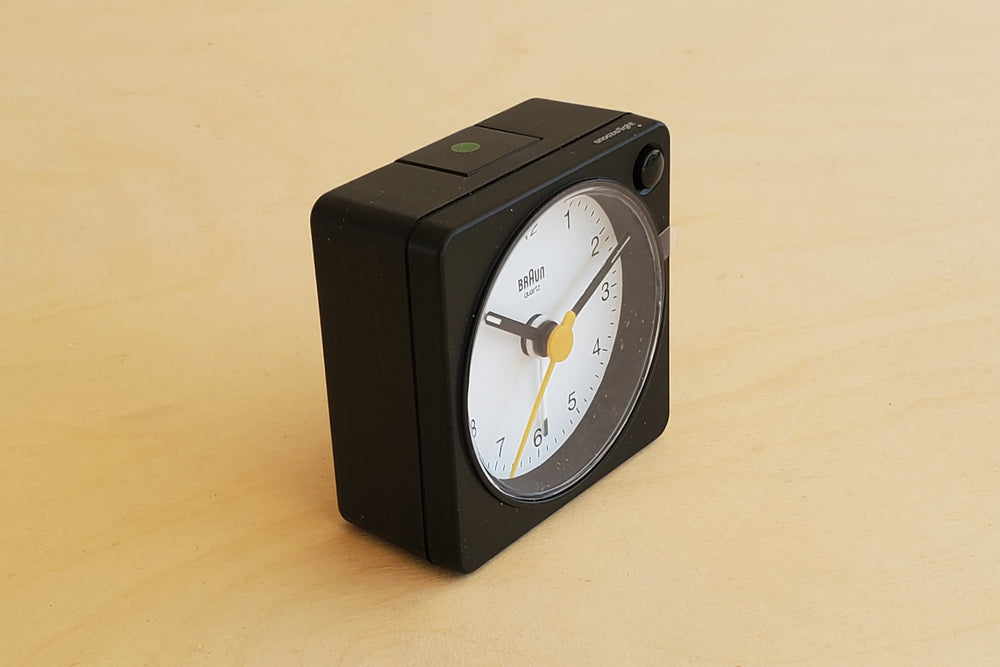 Classic square and analogue Braun Alarm Clock in black with white dial..
