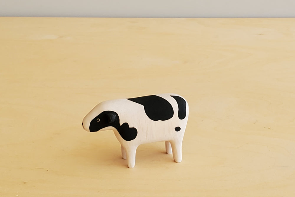 T-lab wooden animals are handmade in Bali from albizia wood, a lightweight fast-growing wood from the South Pacific. A speckled cow.