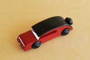Danish Wood Small sedan in red with black roof designed by Kay Bojesen.