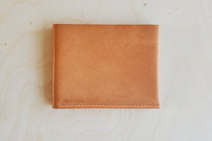 
            
                Load image into Gallery viewer, Simple Flap wallet in Natural leather and natural stitching from architect Alice Park shown closed.
            
        