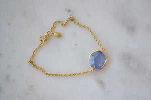
            
                Load image into Gallery viewer, Alternate view of The Single Stone Bracelet designed by Pippa Small also known as the Light and Space bracelet is a single bezel set Tanzanite stone set inline on an 18k gold chain, accented with a gold bead, and secured with lobster clasp forms this bracelet. 
            
        