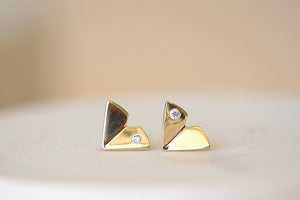 
            
                Load image into Gallery viewer, Large Origamin Stus with diamonds by Kaylin Hertel are Perfectly minimal gold origami bird studs in 14k yellow gold with one diamond each.
            
        
