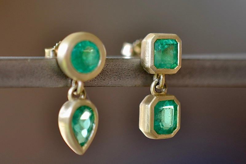 Asymmetric Duo Emerald Earring by Elizabeth Street are bezel set mixed shape and mismatched earrings with post closure in deep green Columbian Emeralds sold as a pair and handmade in Los Angeles.  