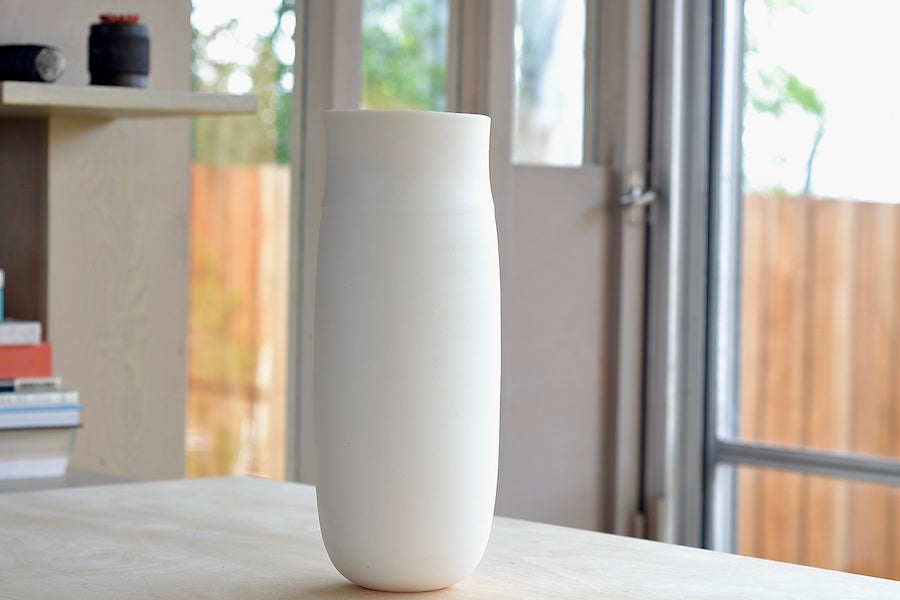 Lilith Rockett Tall vase is reminiscent of an eggshell. It is hand thrown porcelain with gloss glaze on the interior and an unglazed exterior that has been sanded smooth and it is very stable despite its rounded bottom. Handmade in Portland, Oregon. 