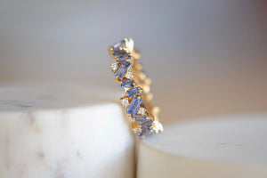 Suzanne Kalan Baby Blue Sapphire and Diamond band is a A ring made out of pronged baby blue sapphire baguettes with interspersed round white diamonds on an 18k yellow gold band in firework setting.. 
