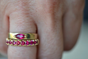 Euro Wedding Band in Ruby by Elizabeth Street is a rose cut half eternity euro band made out of hot pink magenta rubies set into this unique band that is made for stacking, 14k gold band that has a nearly flat back or underside for ultimate comfort.  Handmade in Los Angeles.