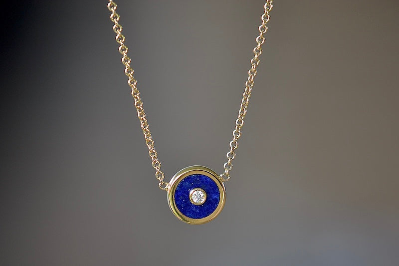 Mini Compass Pendant Necklace in Blue Lapis by Retrouvai with round white diamond accent on 16" 14k yellow gold chain.