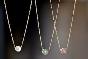 
            
                Load image into Gallery viewer, Mini Compass Pendant Necklace in Dark Mother of Pearll, Green Turquoise and Pink Opal by Retrouvai with round white diamond accent on 16&amp;quot; 14k yellow gold chain.
            
        