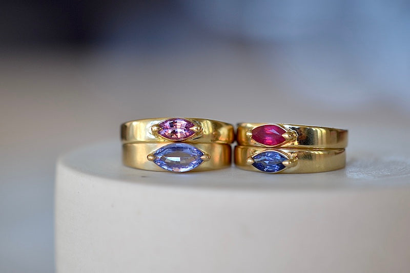 Four stoned slim Band rings in blue, purple, lilac and pink sapphire and ruby by Elizabeth Street.