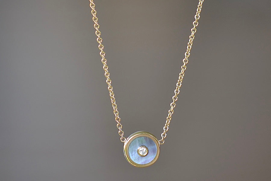 
            
                Load image into Gallery viewer, Mini Compass Pendant Necklace in Dark Mother of Pearl by Retrouvai with round white diamond accent on 16&amp;quot; 14k yellow gold chain.
            
        