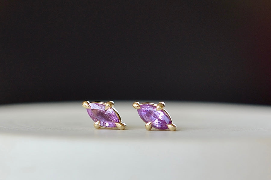 
            
                Load image into Gallery viewer, Eagle Claw Stud Earrings in Purple Sapphire by Elizabeth Street Jewelry are Marquise Sapphire Stud Earrings in violet purple to lilac that are bezel set marquise cut sapphires in a four prong eagle claw setting with post closure in 14k satin gold form these elegant everyday studs.
            
        