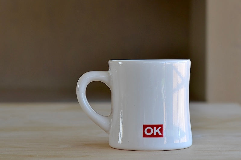 
            
                Load image into Gallery viewer, Alternate side of The OK mug is a large ceramic diner mug with &amp;quot;OK EVERYDAY&amp;quot; written on one side and our logo on the other. Los Angeles. Made in the USA.
            
        