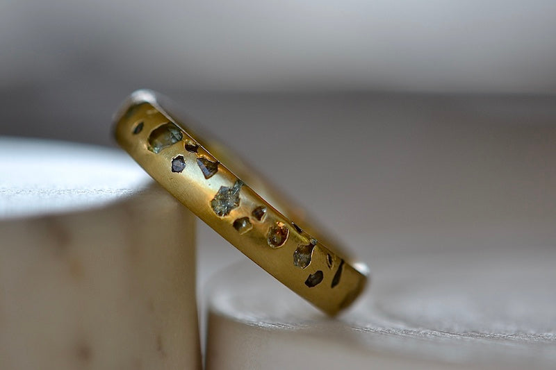 
            
                Load image into Gallery viewer, Polly Wales Green Sapphire Confetti Band in size 6 and in 18k yellow recycled gold.
            
        