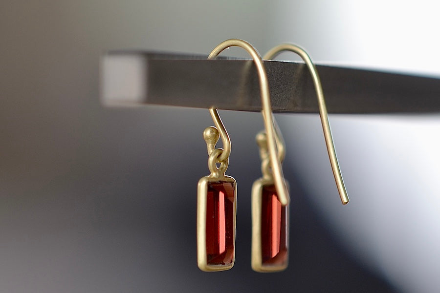 Side view of Extra Small XS Baguette Earrings in Garnet by Tej Kothari are Smooth, translucent and rectangular Garnet baguettes set in 18k yellow gold with gold ear wire.