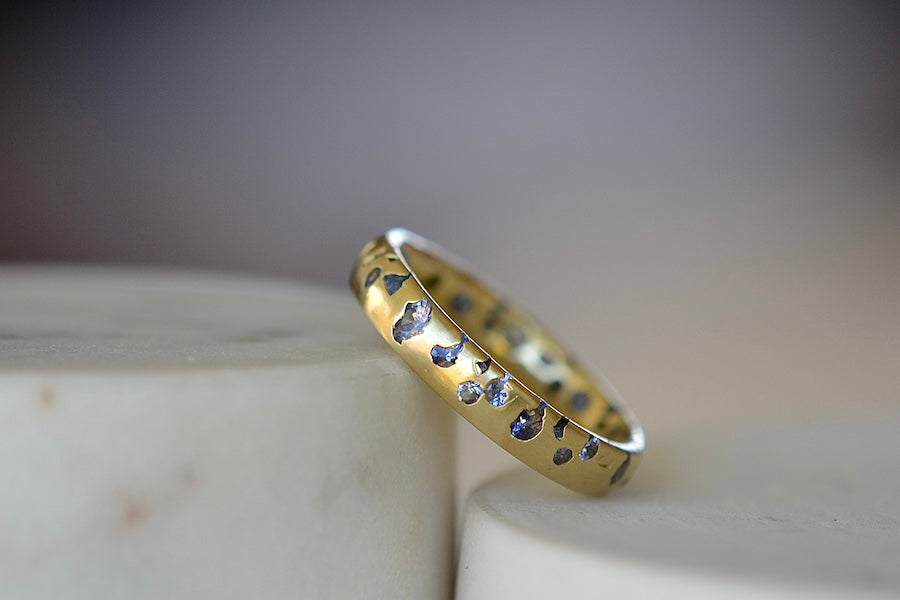 
            
                Load image into Gallery viewer, The Cornflower Blue Sapphire Confetti Band designed by Polly Wales is a narrow 18k yellow recycled gold wedding band/ring with speckled ombre light blue sapphires around the circumference. It is cast not set and handmade in Los Angeles.
            
        