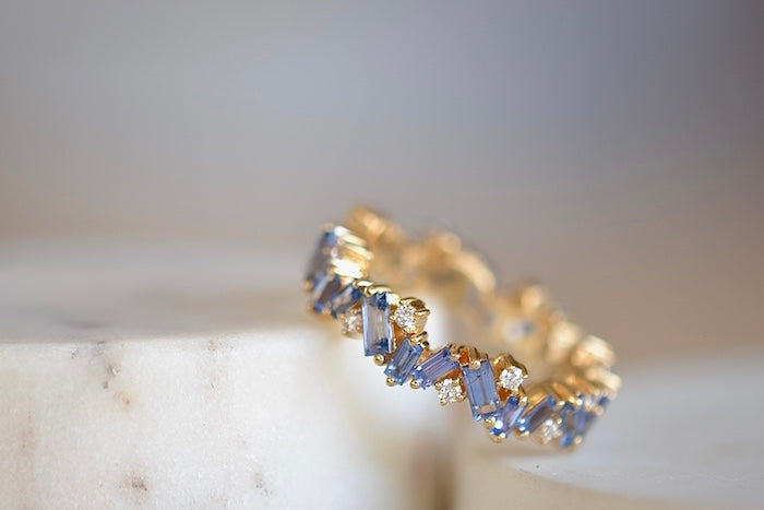Suzanne Kalan Baby Blue Sapphire and Diamond band is a A ring made out of pronged baby blue sapphire baguettes with interspersed round white diamonds on an 18k yellow gold band in firework setting.. 