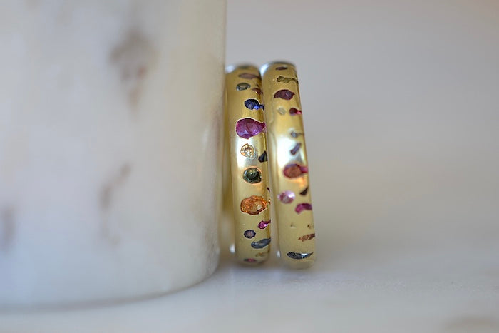 Two Polly Wales Classic Confetti band rings in different sizes available at OK.