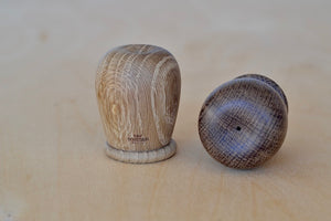 Kay Bojesen "Menagerie" Salt and Pepper shaker set designed in Denmark in oak and smoked oak that is turned 2 3/8" tall and 1 5/8" diameter. Containers have holes on the top and a lid on the bottom with Interior coated with a food safe finish that also protects the containers from color stains.