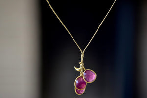 
            
                Load image into Gallery viewer, The Colette Set Cluster with Moon and Ruby Necklace is a  cluster of three bezel set and lightly faceted ruby stones, accompanied by a gold moon, all in 18k yellow gold on a 22&amp;quot; golden waxed cotton cord form this necklace. 
            
        