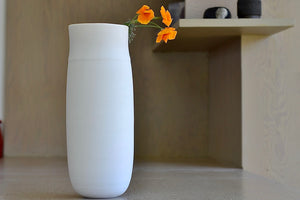 Lilith Rockett Tall vase is reminiscent of an eggshell. It is hand thrown porcelain with gloss glaze on the interior and an unglazed exterior that has been sanded smooth and it is very stable despite its rounded bottom. Handmade in Portland, Oregon. 